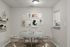 Chic dining area with a modern round table, elegant chairs, and stylish wall art, perfect for cozy dinners.