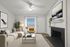 Bright and inviting living room with a cozy beige sofa, chic decor, and a modern fireplace.