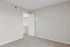 Bright and inviting bedroom with plush carpet flooring, freshly painted walls, and a spacious walk-in closet.
