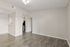 Modern apartment interior with elegant wood flooring, bright open space, and kitchen entry, perfect for a stylish lifestyle.