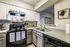 Charming kitchen with sleek countertops, modern appliances, and stylish cabinetry, perfect for cooking enthusiasts.