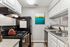 Charming kitchen with modern appliances, bright artwork, and sleek countertops, perfect for culinary creativity.