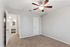 Bright, airy room with plush carpet and modern ceiling fan, showcasing a neutral palette perfect for personalization.