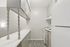 Chic galley kitchen with modern appliances, sleek cabinetry, and stylish wood flooring for a contemporary living space.