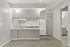 Bright, modern kitchen with sleek cabinetry, ample counter space, and minimalist design in a stylish apartment.