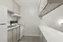 Bright and modern kitchen with sleek countertops, ample cabinetry, and contemporary appliances.