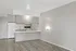 Modern open-concept kitchen with sleek cabinetry, integrated appliances, and bright ambient lighting.