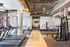 Modern fitness center featuring state-of-the-art treadmills, weight machines, and a stylish decor.
