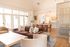 Inviting living area at ReNew Howard Crossing with modern seating, natural light, and elegant decor, perfect for relaxation and social gatherings.