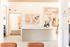 Bright and welcoming apartment reception area at ReNew Howard Crossing with modern design, featuring artistic wall decor and a chic curved desk.