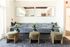 Elegant lounge area at ReNew Howard Crossing featuring a plush gray sofa with modern round tables, green ottomans, and stylish decor, creating a welcoming atmosphere.