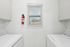 Bright and efficient laundry room featuring a window and modern appliances, perfect for urban living.