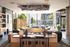 Modern living area with sleek decor, featuring floor-to-ceiling windows and stylish wood accents, overlooking a lush garden view.