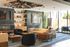 Luxurious modern living room with elegant decor, plush seating, and expansive windows allowing natural light to fill the space.
