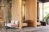 Contemporary lobby area with stylish seating, wooden divider accents, and lush greenery, offering a welcoming atmosphere.
