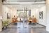 Contemporary meeting room with glass walls, modern furniture, and stylish decor, perfect for business gatherings.
