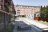 Modern apartment complex with a stylish poolside area, surrounded by sleek architecture and inviting outdoor seating.