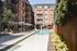 Elegant apartment complex courtyard featuring a luxurious pool, inviting lounge chairs, and lush greenery, perfect for relaxation and leisure.
