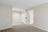 Modern apartment interior featuring soft carpeted flooring and a neutral color palette, offering a spacious and inviting atmosphere.