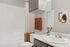 Elegant bathroom featuring modern fixtures, minimalist decor, and a soothing color palette complemented by artistic wall art.