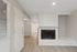 Inviting living space with a charming fireplace, elegant hardwood flooring, and abundant natural light through stylish blinds.