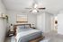 Inviting bedroom featuring a cozy queen-sized bed with stylish decor, soft carpeting, and ample natural light.
