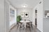 Chic dining area with modern decor, featuring a stylish round table, elegant chairs, and abundant natural light.