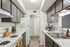 Charming kitchen featuring sleek countertops, dark cabinetry, and modern appliances in a bright, inviting space.