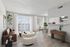 Bright and modern living space featuring sleek decor, a cozy seating area, and a stylish dining nook with abundant natural light.