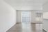 Bright and airy living space featuring large windows, stylish wood flooring, and modern blinds for a sleek interior.