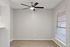 Bright and inviting room with modern ceiling fan, large window, and stylish wood flooring perfect for a cozy dining area.