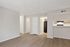 Modern apartment with sleek finishes, featuring a spacious open layout, wood flooring, and a stylish kitchen with contemporary appliances.