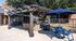 Inviting outdoor patio area with a stylish pergola and vibrant blue seating, perfect for relaxing or social gatherings.
