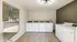 Bright and modern laundry room with multiple washing machines and wooden flooring, perfect for efficient and easy cleaning.