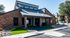 Charming brick apartment building with modern design, featuring accessible parking and landscaped surroundings.