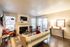 Cozy living room with stylish decor, featuring a modern fireplace, plush seating, and warm lighting accents.