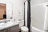 Chic bathroom with modern vanity, polka dot shower curtain, and stylish decor for a cozy apartment vibe.