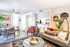 Chic open-concept living area with modern dining set, cozy sofa, and stylish decor, perfect for entertaining.