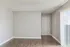 Contemporary apartment entryway with sleek hardwood flooring and large vertical blinds, inviting natural light.