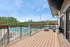 Modern apartment balcony overlooking a refreshing pool and lush greenery, perfect for relaxation and leisure.
