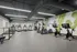 Modern fitness center with state-of-the-art equipment, sleek design, and vibrant wall mural.