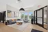 Contemporary and inviting apartment lobby with stylish seating, modern art, and abundant natural light through large windows.