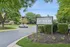 Inviting entrance to ReNew Poplar Creek surrounded by lush green landscaping and modern architecture.
