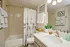 Inviting bathroom with elegant fixtures, featuring a chic shower curtain, modern faucet, and decorative touches that create a serene ambiance.
