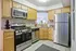 Modern kitchen featuring stainless steel appliances, elegant wooden cabinetry, and spacious countertops.