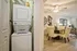 Chic apartment interior showcasing a modern dining area with elegant beige chairs, stylish decor, and a convenient in-unit washer and dryer.
