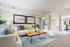 Bright and inviting living room with plush seating, stylish decor, and an open layout leading to a modern kitchen.