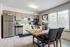 Chic modern kitchen with stainless steel appliances, sleek cabinetry, and elegant dining area with abundant natural light.