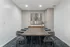 Sophisticated dining room with modern art, elegant wood table, and stylish chairs.