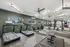 Modern fitness center with state-of-the-art treadmills, exercise bikes, and weightlifting equipment in a spacious, well-lit area.